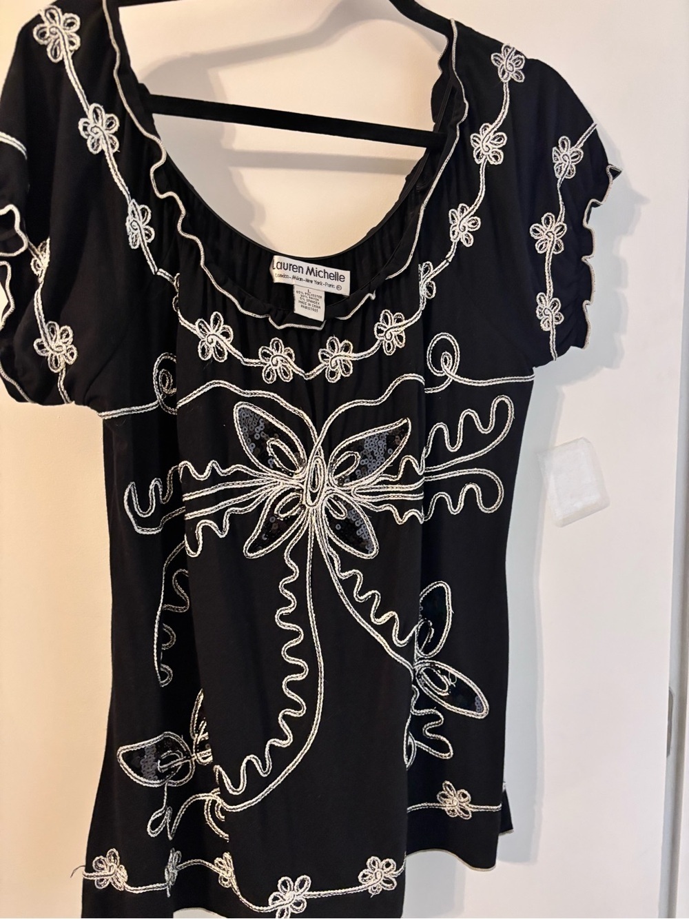 Lauren Michelle Black Sleeveless Top with White Floral Embroidery Trim